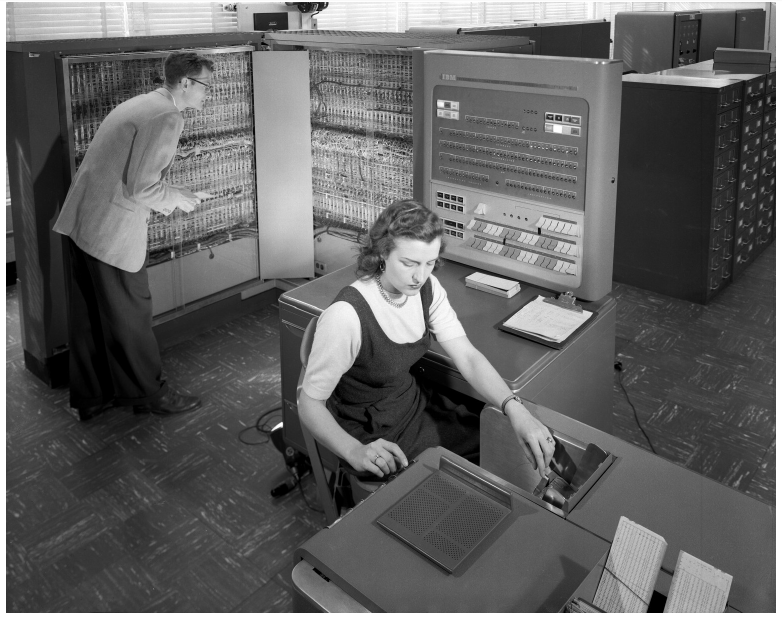 An IBM 704 installation at NACA Langley in 1957. A shared computing facility needs a way to organize access to its resources.