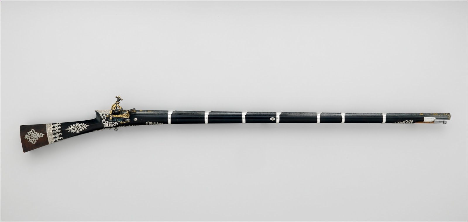 A long firearm with decorative detailing