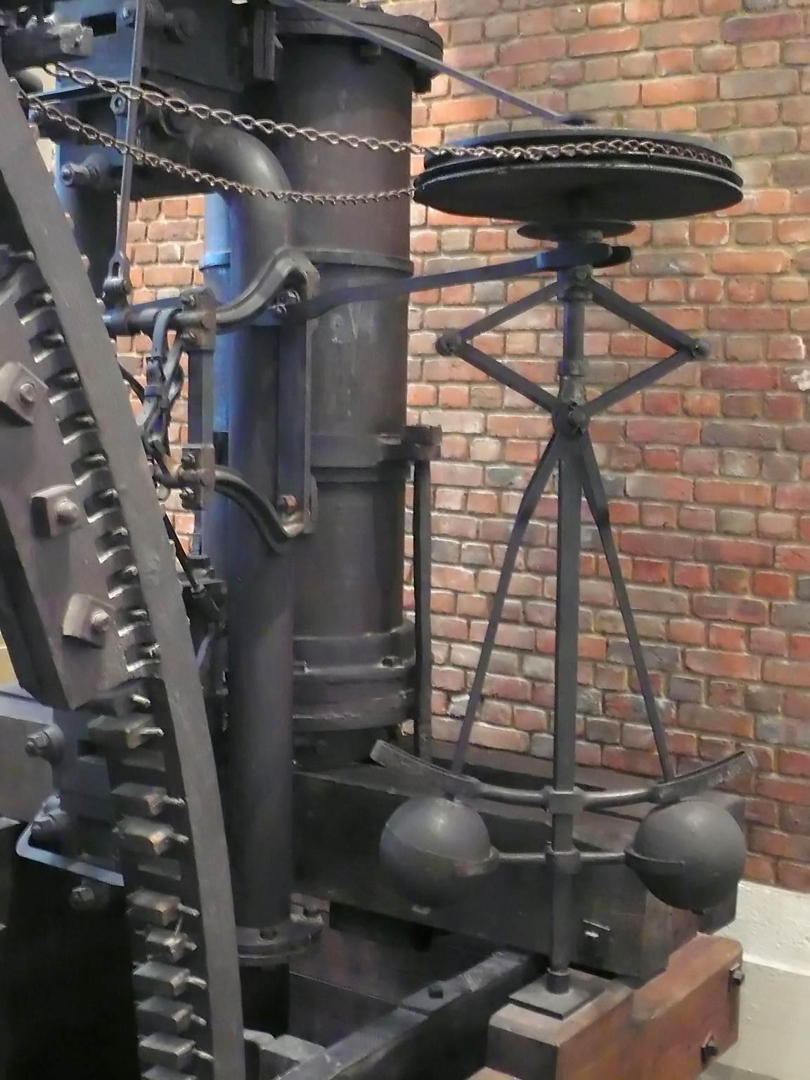 Rotating governor mechanism used to regulate an engine