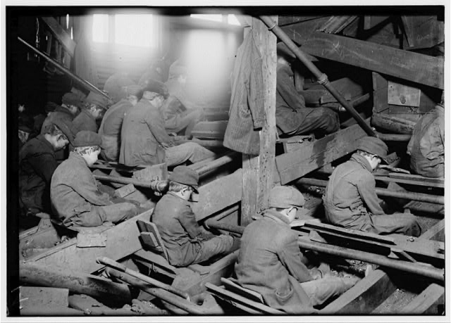 Workers sorting material in an industrial workplace