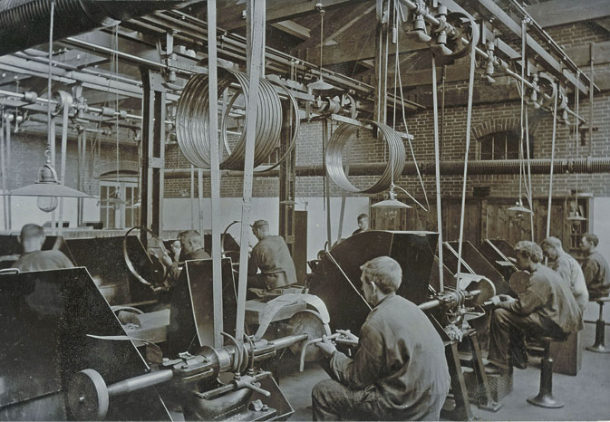 Machine-shop workers and overhead belt drives